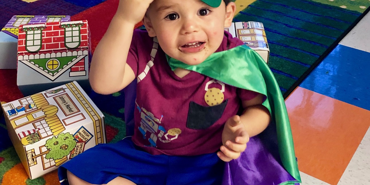 toddler dressed up as a super  hero