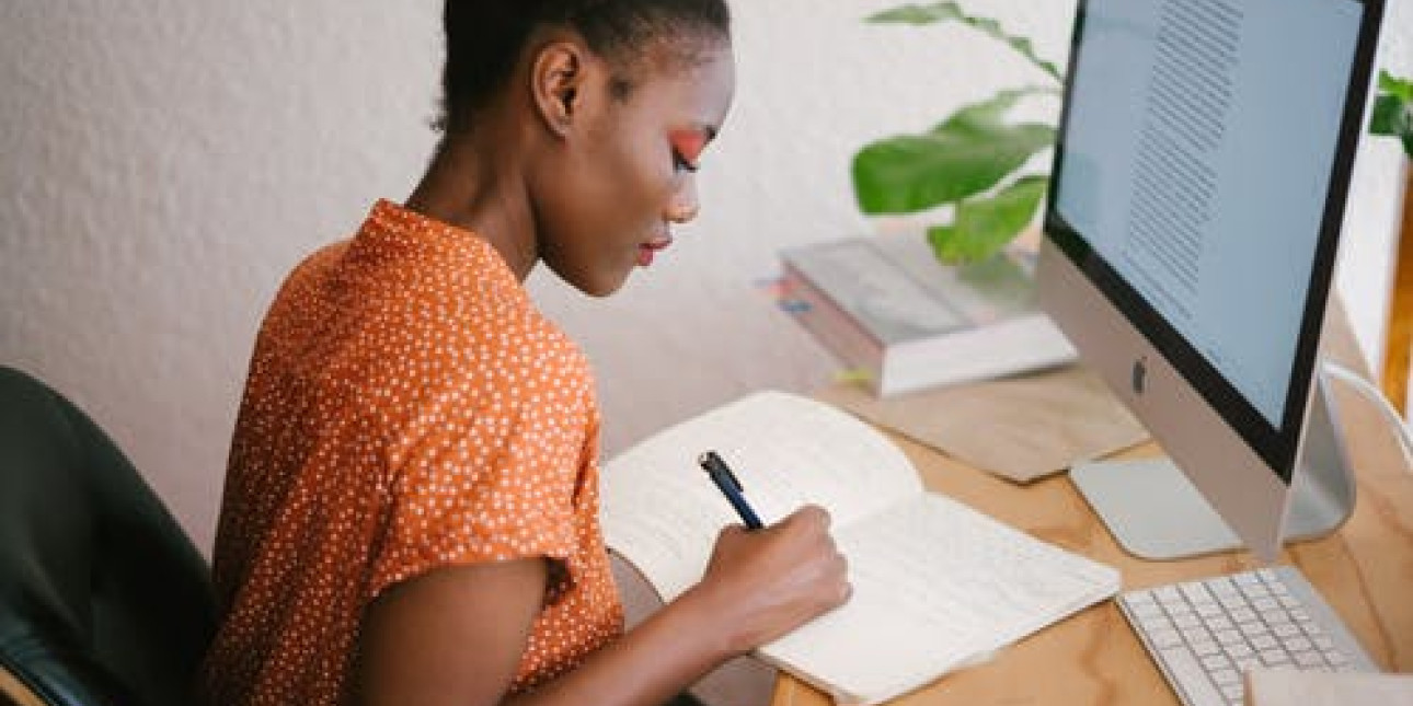 one woman sitting in front of computer 